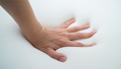 A Close-Up View of a Hand on a White Foam.