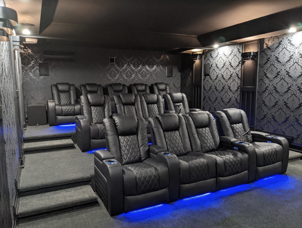 Black-Tuscany-chairs-are-comfortable-and-high-quality-and-look-great-in-this-black-monochrome-theater-with-french-black-and-grey-floral-wallpaper